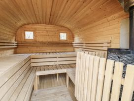A sauna with wooden benches and windows at Rabbit Hole near Stamford