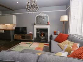 A living room with a sofa and television at Unicorn Cottage 