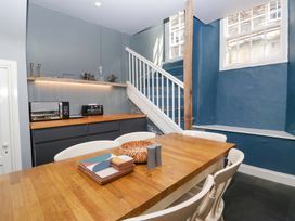 A kitchen with a table and chairs at Unicorn Cottage