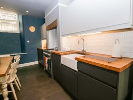 A kitchen with a sink and stove at Unicorn Cottage
