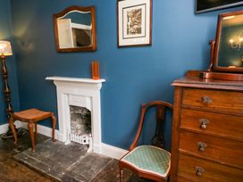 A sitting room with furniture and decor at Unicorn Cottage