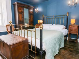A bedroom with a bed and wardrobe at Unicorn Cottage