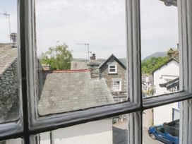 A view of rooftops and buildings from a window at Unicorn Cottage in 