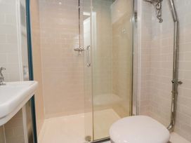 A bathroom with a shower, sink, and toilet at Unicorn Cottage in 