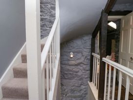 A staircase and railing in a hallway at Unicorn Cottage