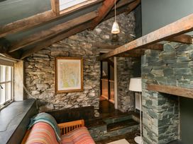 A living room with a sofa and a map on the wall at Unicorn Cottage