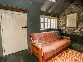 A snug with a sofa and a door at Unicorn Cottage