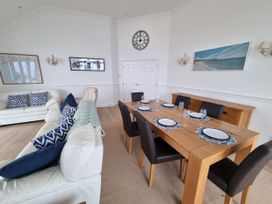 A dining room with a table set for dinner at Sea View Beach Apartment in Thurlestone
