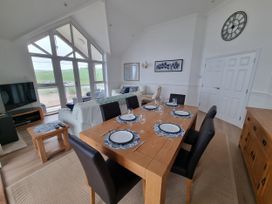 A dining area with a table and chairs at Sea View Beach Apartment in Thurlestone