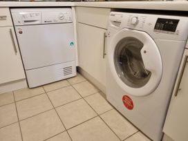 A dishwasher and washing machine in a kitchen at Sea View Beach Apartment Thurlestone