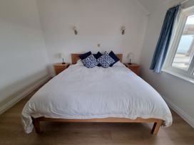 A bedroom with a double bed and nightstands at Sea View Beach Apartment in Thurlestone