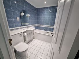 A bathroom with a sink, toilet and bathtub at Sea View Beach Apartment in Thurlestone