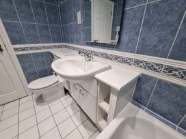A bathroom with a sink and toilet at Sea View Beach Apartment Thurlestone