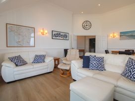 A living room with a sofa and armchair at Seaview Beach Apartment, 11 Thurlestone Rock Thurlestone