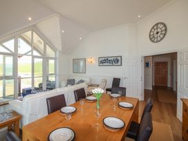 A dining room with a table and chairs at Seaview Beach Apartment, 11 Thurlestone Rock