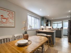 A kitchen with a dining table and chairs at Rock View in Trethurgy near St Austell