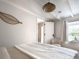 A bedroom with a bed and a window at Rock View in Trethurgy near St Austell