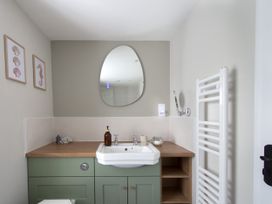 A bathroom with a sink and mirror at Rock View in Trethurgy near St Austell