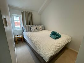 A bedroom with a bed and bedside table at 23 Millhams Street in Christchurch