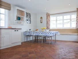 A dining area with a table and chairs next to a window seat in a kitchen at Holm Oak Lodge Tendring near Weeley