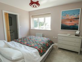 A bedroom with a bed and a window at 36 Parc Delfryn
