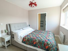 A bedroom with a bed and bedside table at 36 Parc Delfryn