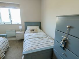A bedroom with two beds and a window at 36 Parc Delfryn