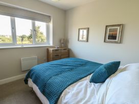 A bedroom with a bed and window at 36 Parc Delfryn