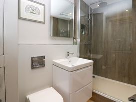 A bathroom with a toilet sink and a walk in shower at Holme Fell View in Sedbergh