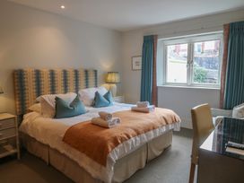 A bedroom with a double bed and window at 22 Dart Marina in Dartmouth