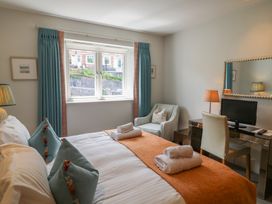 A bedroom with a bed, desk, and chair at 22 Dart Marina, Dartmouth