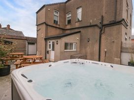 An outdoor area with a hot tub and seating at Lund House in Ulverston