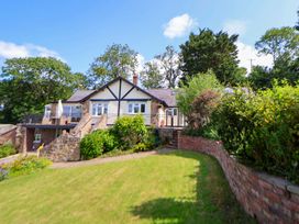 A house with a garden and balcony at The Old Barn in Pentre Celyn