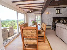 A dining room with a table and chairs at The Old Barn in Pentre Celyn