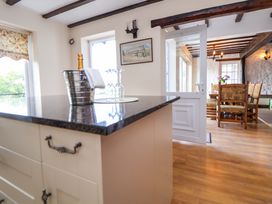 A kitchen with an island and dining area at The Old Barn in Pentre Celyn