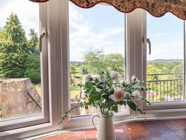 A window with a vase of flowers at The Old Barn in Pentre Celyn