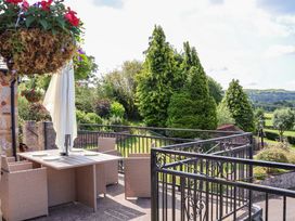 A dining area with a table and chairs at The Old Barn in Pentre Celyn