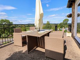 An outdoor dining area with table and chairs at The Old Barn in Pentre Celyn