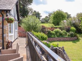 An outdoor view of a balcony with plants and garden at The Old Barn in Pentre Celyn