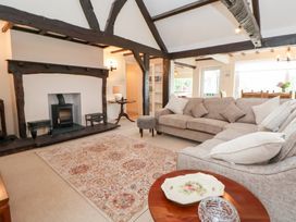 A living room with a sofa and fireplace at The Old Barn in Pentre Celyn