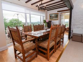 A dining room with a table and chairs at The Old Barn in Pentre Celyn