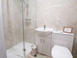 A bathroom with a shower and sink at The Old Barn in Pentre Celyn