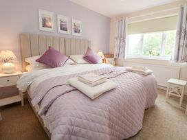 A bedroom with a bed and window at The Old Barn in Pentre Celyn