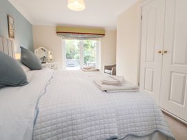 A bedroom with a bed and vanity at The Old Barn in Pentre Celyn
