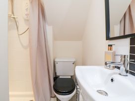 A bathroom with shower, toilet, and sink at The Old Barn in Pentre Celyn