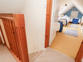 A hallway with a staircase leading up to a bedroom at The Old Barn in Pentre Celyn