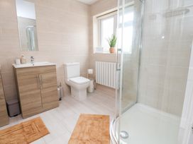 A bathroom with a sink and shower at The Old Barn in Pentre Celyn