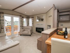A living room with a sofa and armchair at Aspen in Denny
