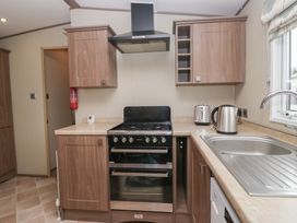 A kitchen with a gas oven and sink at Aspen in Denny
