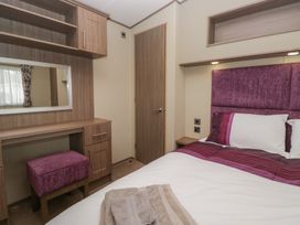 A bedroom with a bed and a desk at Aspen in Denny